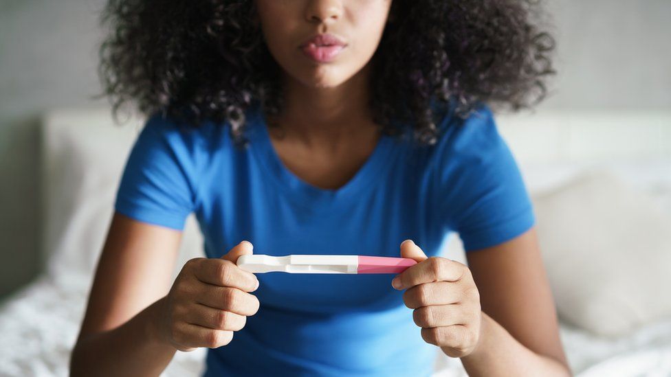 Woman with pregnancy test