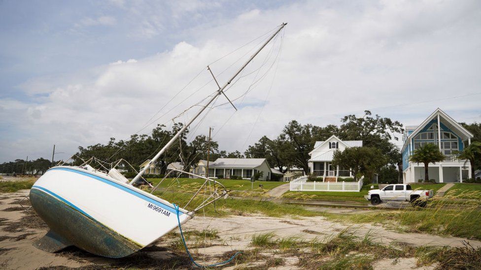 A sailboat sits on the beach after Hurricane Ida passed on 30 August in Bay St. Louis, Mississippi