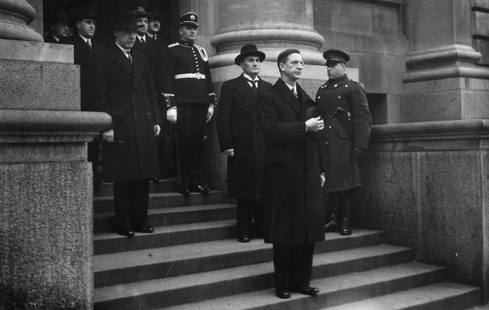 Taoiseach de Valera taking the salute at Dublin's government buildings after finalising the new Irish constitution in 1937