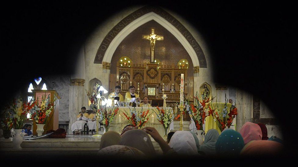 Pakistani Christians gather during an Easter service at a church in Lahore on 27 March 2016