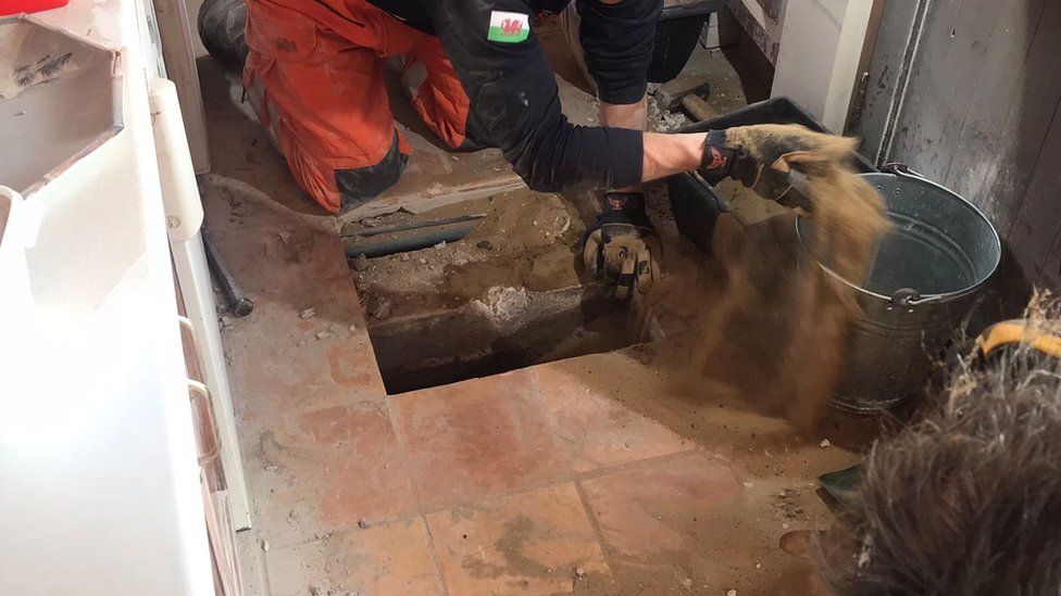 The rescuers dug through the property's kitchen as they searched for the pet