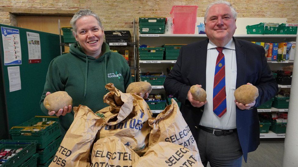 Helen Gilbert and Paul Kunes holding potatoes
