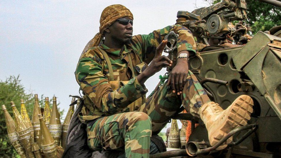 Sudan fighter sitting near a turret and rocket propelled grenades. 30 August