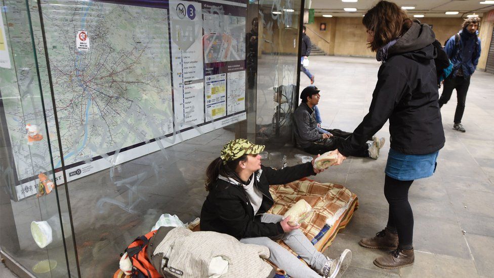 Volunteers give out sandwiches to the homeless in Hungary's capital city Budapest.