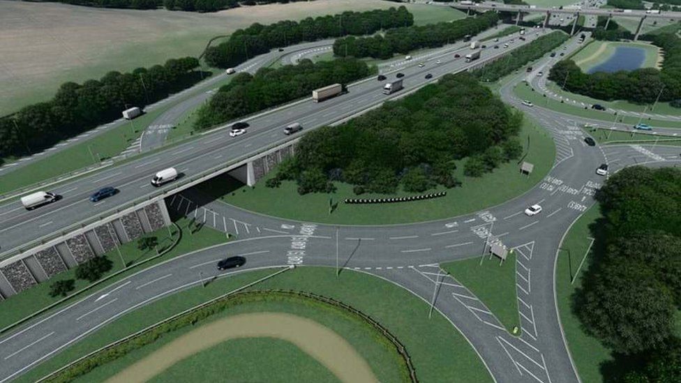 An artist's CGI impression of the stockbury roundabout junction when finished which features a large central roundabout with a flyover above a large wooded area.