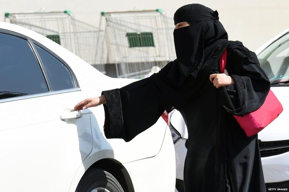 Woman gets a cab in Saudi Arabia