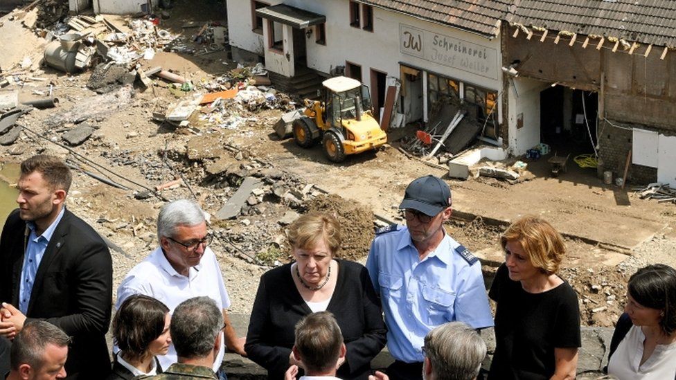Mrs Merkel (centre) and Rhineland Palatinate premier Malu Dreyer (second right) talk to residents in Schuld