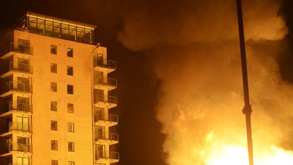 Firefighters worked to protect an apartment building in Belfast