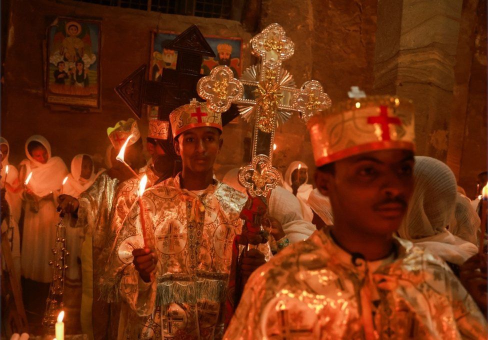 Ethiopian Orthodox deacons hold candles during the Easter Eve mass at the Wukro Cherkos rock-hewn church in Wukro.