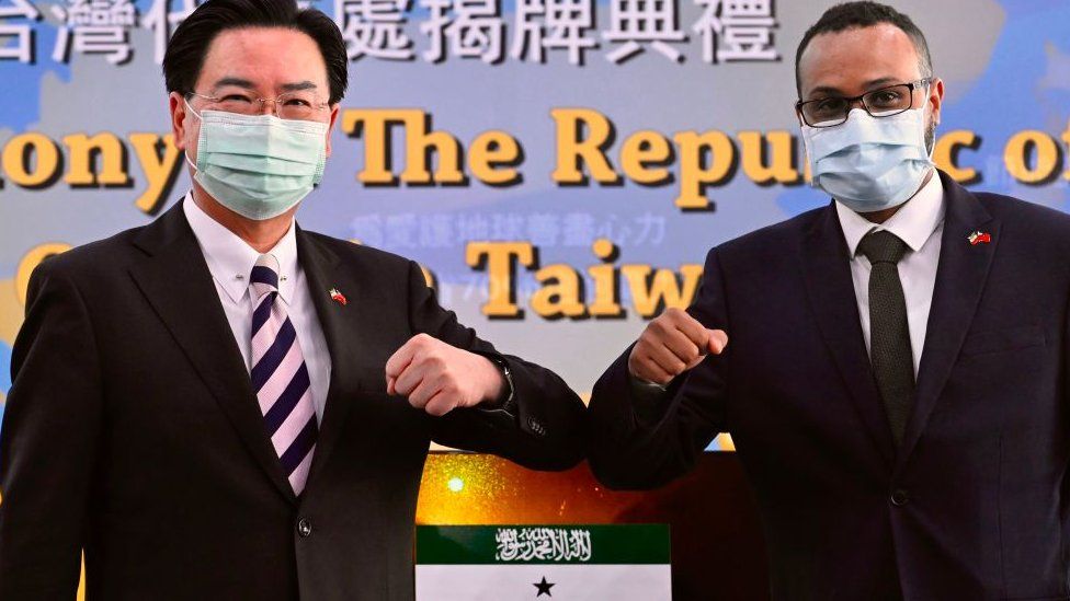 Mohamed Hagi (R), Somaliland's Taiwan representative, bumps elbows while posing with Taiwan's Foreign Minister Joseph Wu during the opening ceremony of the Somaliland representative office in Taipei on September 9, 2020