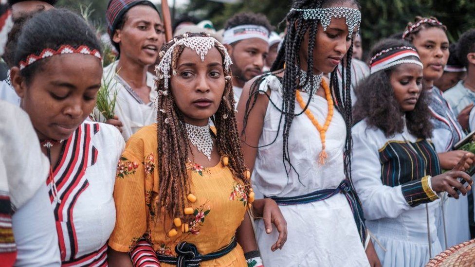 Women in traditional clothing march during the celebration of Irreechaa, the Oromo people thanksgiving holiday, on the shore of a lake near the city of Bishoftu, Ethiopia - October 2021
