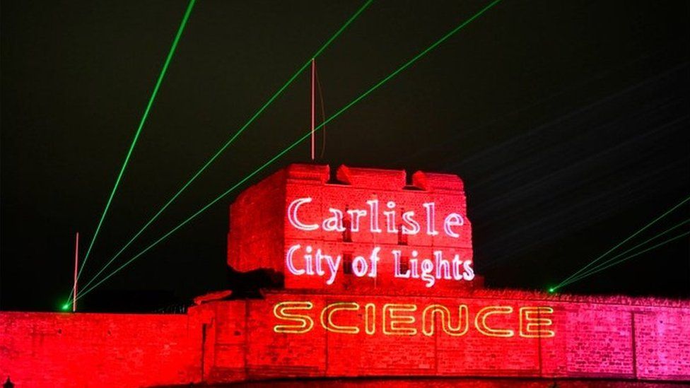 Carlisle Castle lit up in red lights and lasers