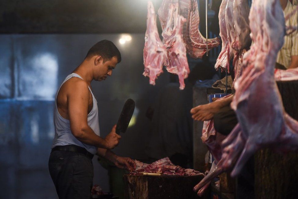 A butcher prepares mutton for a customer at his shop in a local market in Mumbai on January 23, 2020