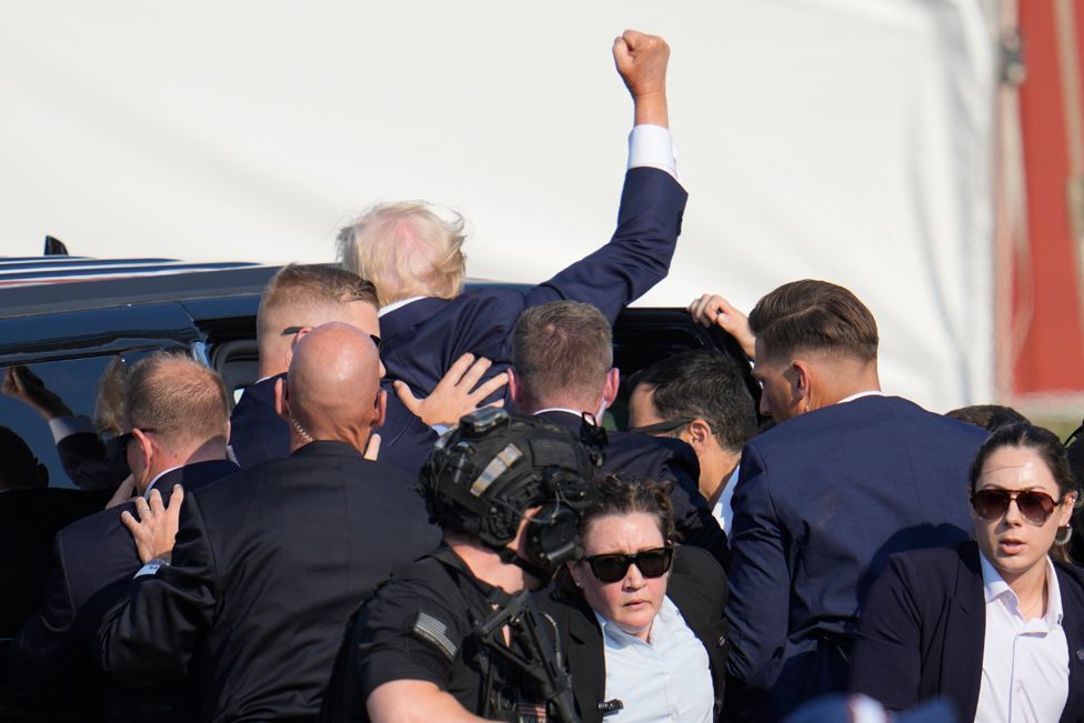 Republican presidential candidate former President Donald Trump is helped off the stage at a campaign event in Butler, Pa., on Saturday, July 13, 2024.