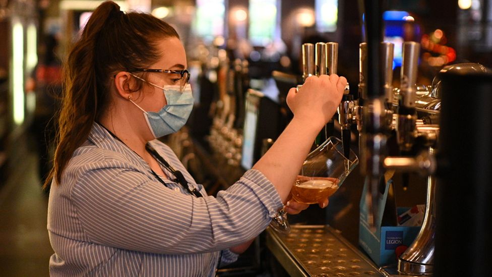 A member of the bar staff pulls a pint in a Wetherspoons pub in Leigh, Greater Manchester, on 22 October 2020