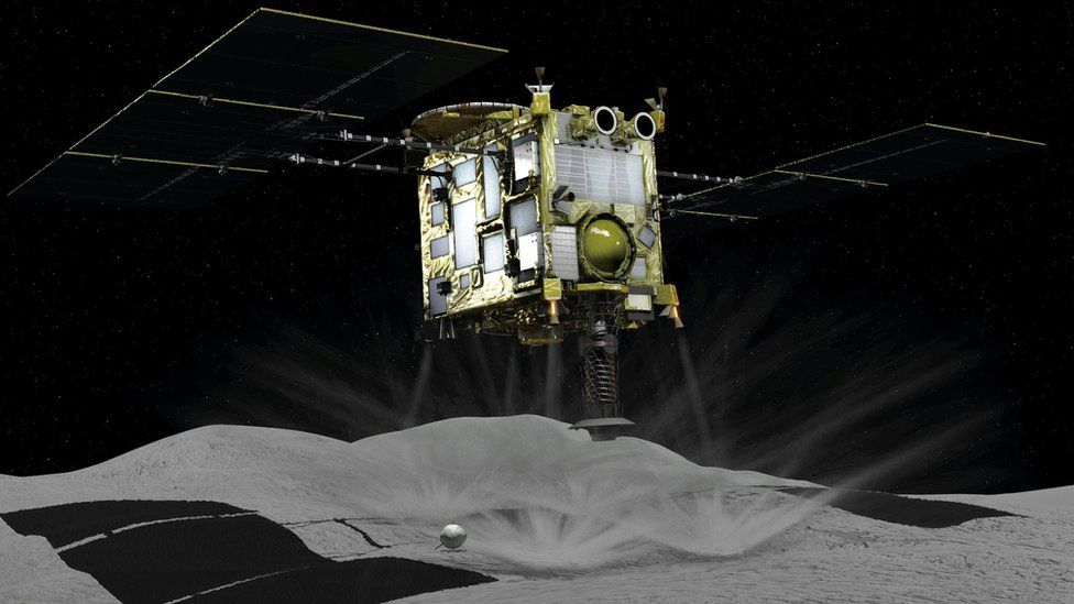 Computer graphic shows Japan Aerospace Exploration Agency's Hayabusa 2 probe touching down on an asteroid