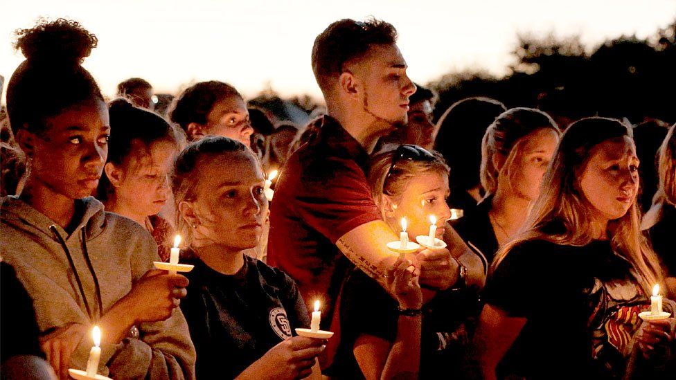 Thousands of mourners hold candles during a candlelight vigil for victims of the Marjory Stoneman Douglas High School shooting in Parkland, Florida on February 15, 2018.