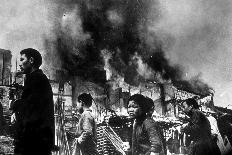 circa 1937: Chinese refugees streaming through the wrecked streets of Chungking, after it had been heavily bombed by the Japanese