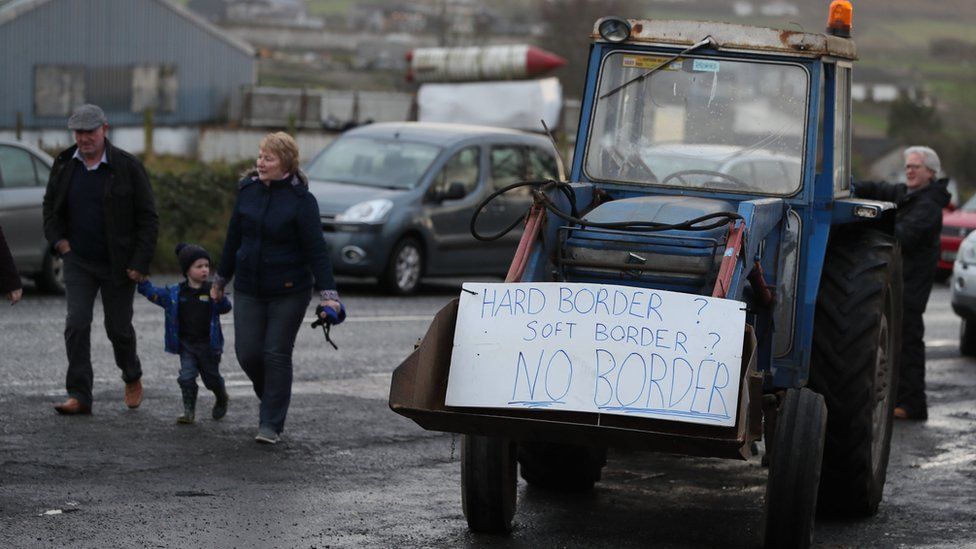 A tractor carrying a sign that reads: Hard Border? Soft border? No border!