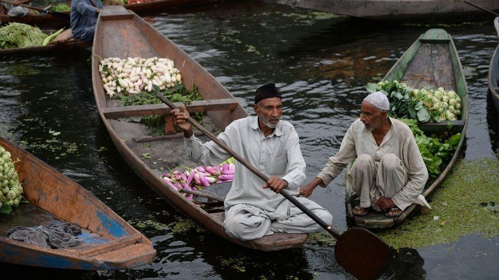 Kashmiri boatmen at the floating vegetable market on Dal lake in Srinagar
