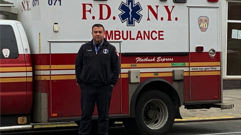 Anthony Almojera in front of his ambulance