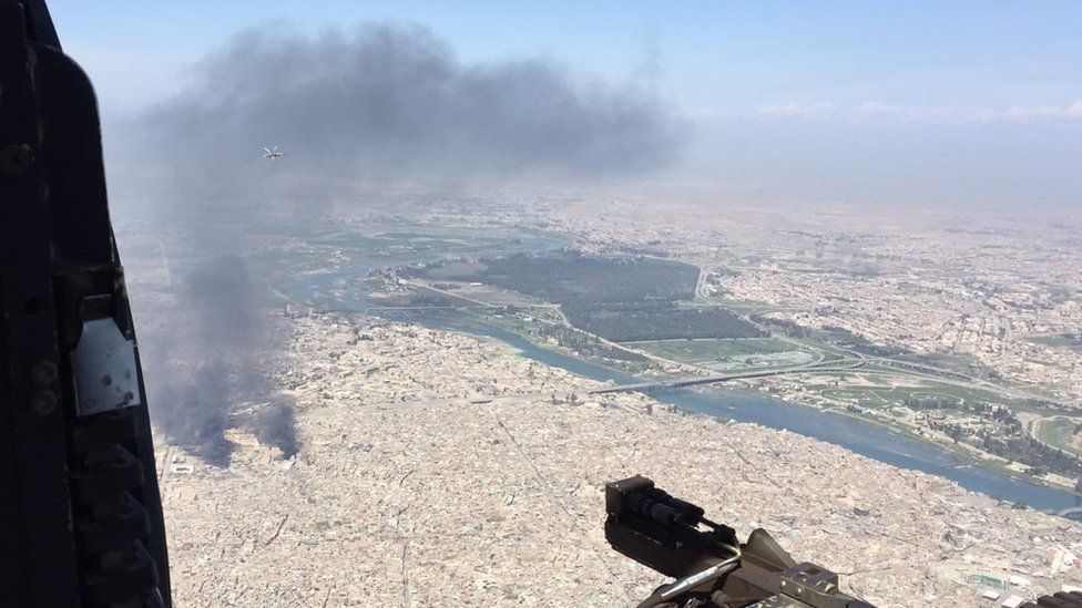 A plume of black smoke is seen above Mosul
