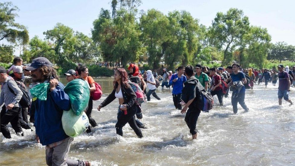 Migrants cross the Suchiate river at the border between Guatemala and Mexico in a bid to get to the US, 20 January 2020