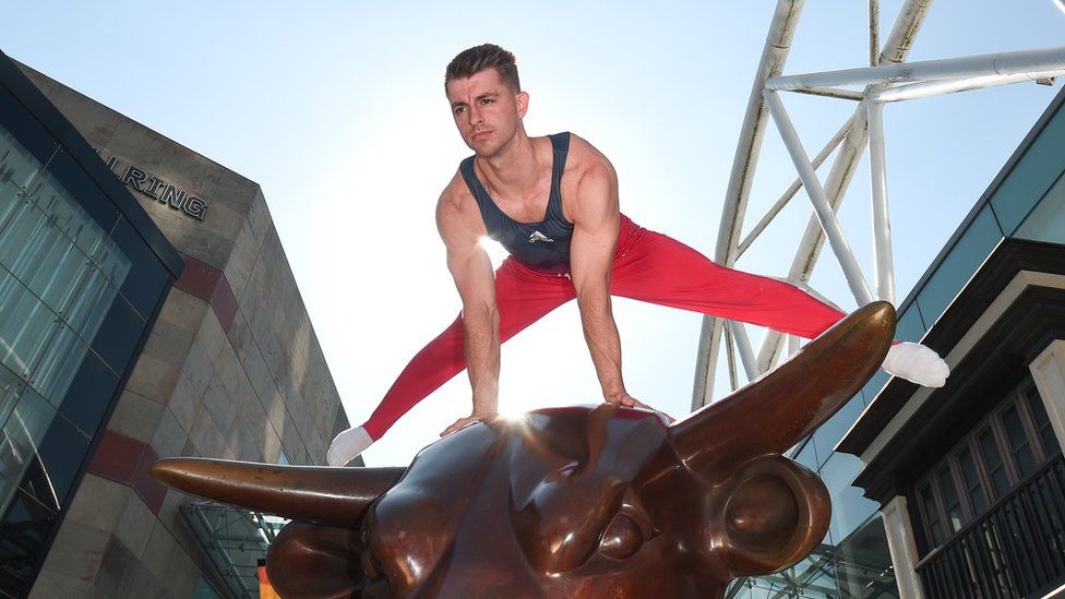 Max Whitlock balancing on metal bull in Birmingham