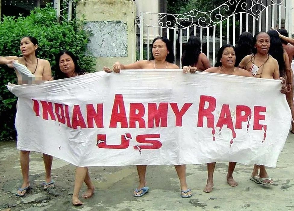 A group of Indian women hold aloft a banner as they stand naked outside the headquarters of the Assam Rifles paramilitary force in Imphal the capital of the far eastern Indian state of Manipur, 15 July 2004, to protest against the 10 July killing of an alleged female insurgent.