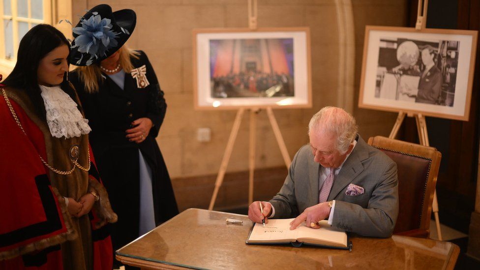 King Charles signs visitors book at Luton Town Hall
