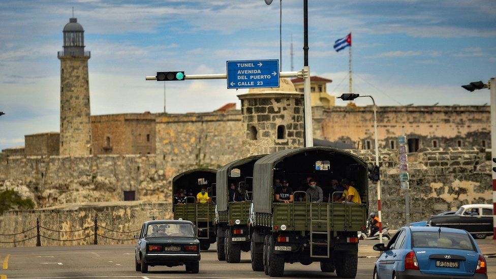 Police vehicles drive along El Paseo del Prado street in Havana, on 15 November 2021