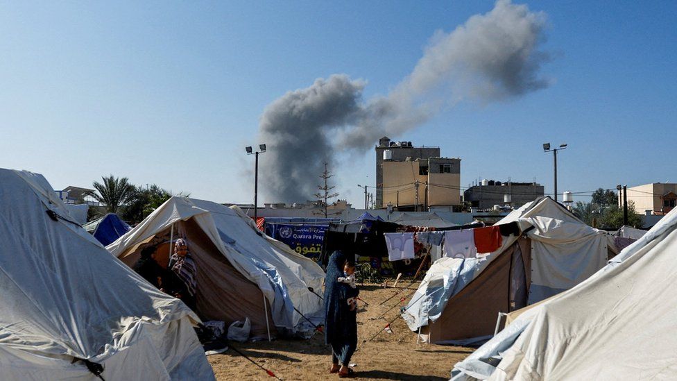 Smoke rises after an Israeli strike near a tented camp for displaced Palestinians in Khan Younis, in the southern Gaza Strip (26 October 2023)