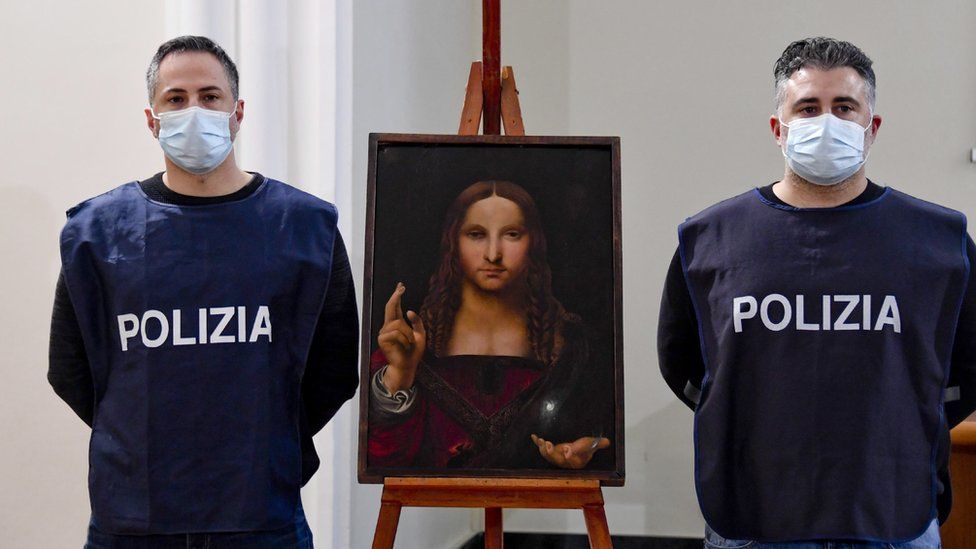 Image shows two police officers stood next to the recovered painting