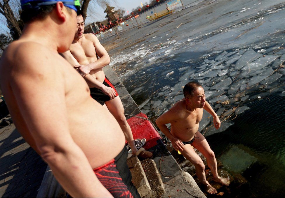 Chinese winter swimming enthusiasts prepare to swim in the half-frozen Houhai lake where the water temperature is one degrees Celsius and the air temperature is minus ten degrees in Beijing city, China, 22 January 2016