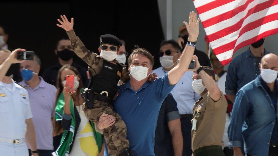 Brazilian President Jair Bolsonaro (C) attends a rally with supporters in Brasilia