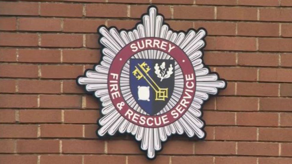 Surrey Fire and Rescue badge on the outside of a building