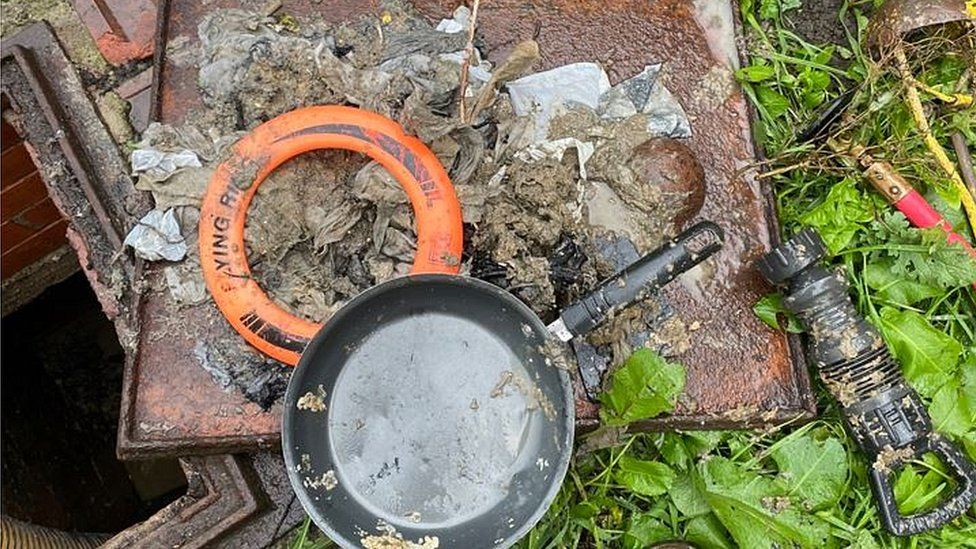 Frying pan and frisbee found in sewer