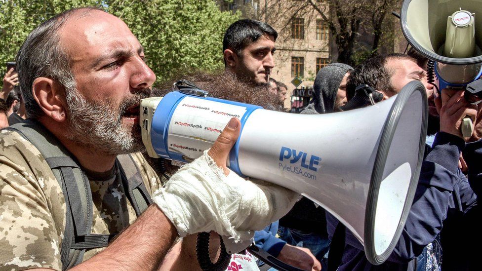 A protester with a megaphone at a demonstration in Armenia