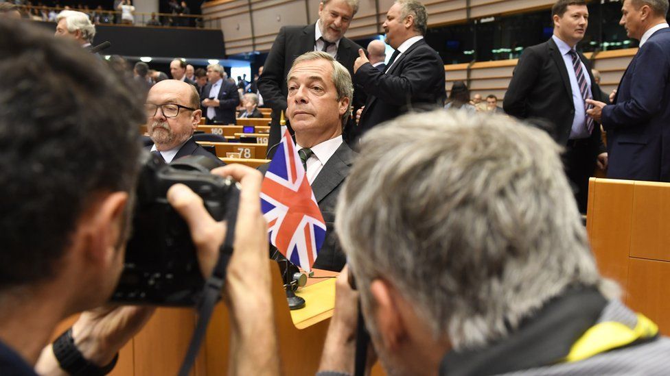 Nigel Farage seated at the European Parliament