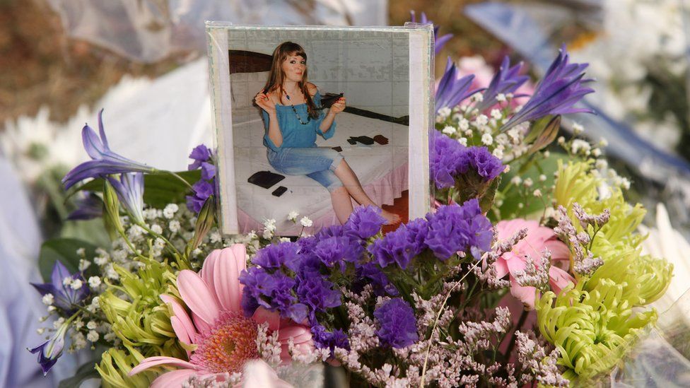 Flowers and a photograph of Catherine Hickman lay adjacent to a tower block on the Sceaux Gardens Estate in Camberwell following a fire on July 6, 2009 in London, England.