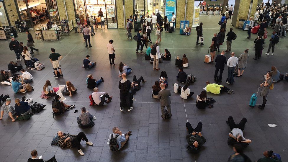 People waiting inside King's Cross station