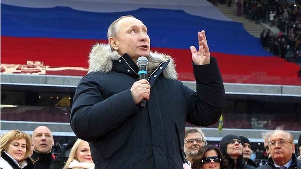 Russian President Vladimir Putin speaks during a campaign concert in March 2018