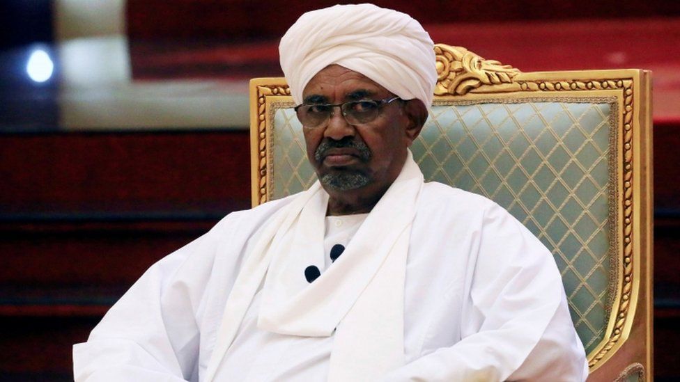 President Omar al-Bashir sitting on a green chair dressed in white at the National Dialogue Committee at his palace in Khartoum on April 5