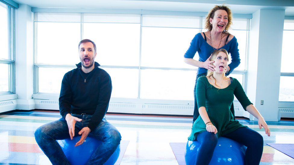 An instructor putting two people through their paces