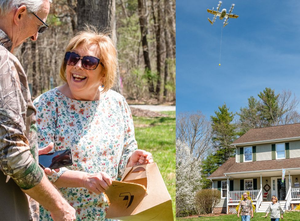 Couple holding package delivered by drone