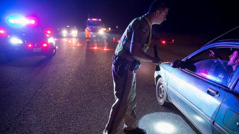 A highway patrol officer directs traffic as residents evacuate Marysville, California, after fears of a collapse Oroville Dam