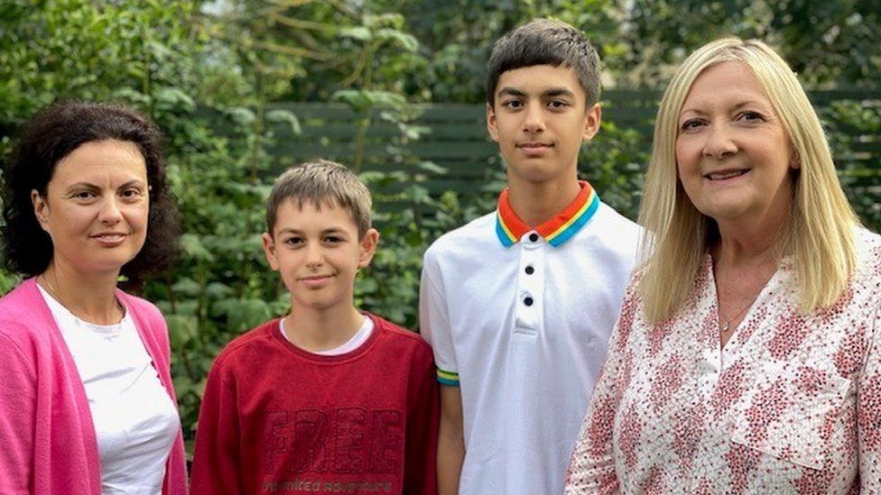 Left to right, Iryna Zhomer,her sons Yurii and Tarras and sponsor Christine Truman