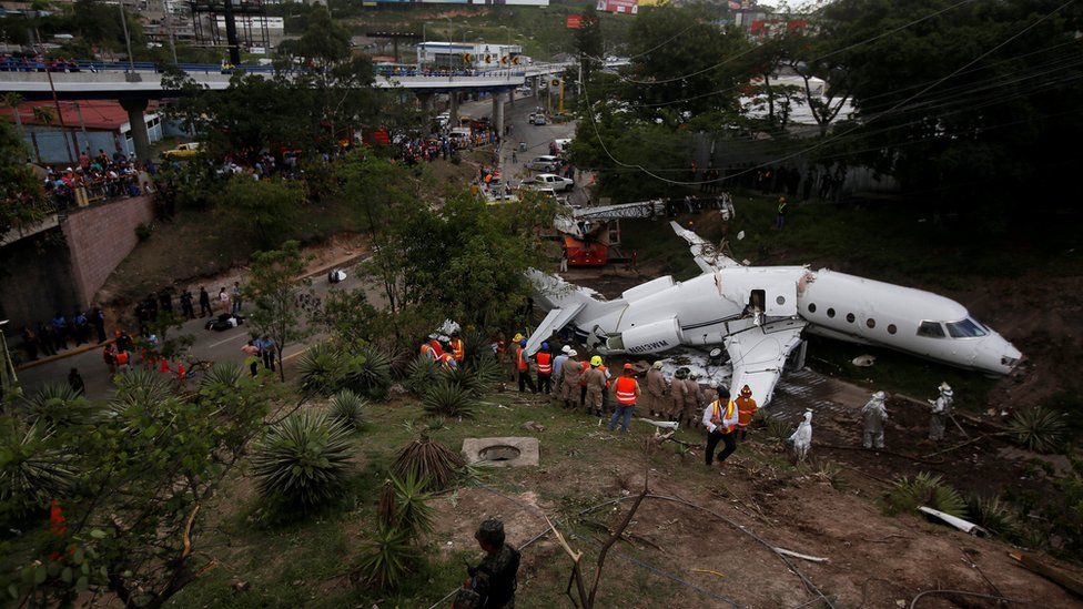 A general view shows rescue workers next to the wreckage of a Gulfstream G200 aircraft
