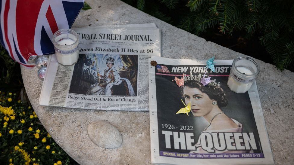 Newspapers are left at a makeshift memorial for Britain's Queen Elizabeth II in New York City on 10 September, 2022.