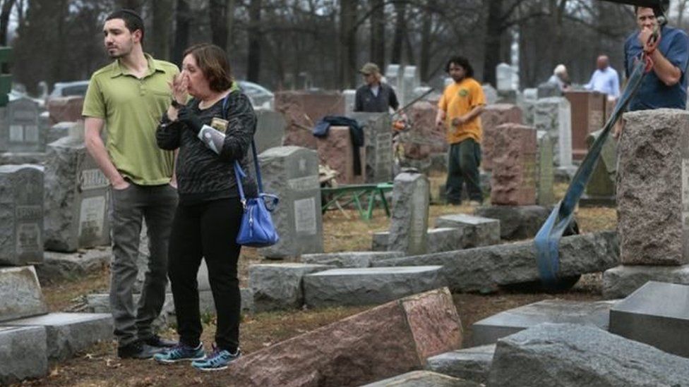 Image of a woman in tears at the Chesed Shel Emeth cemetery in St Louis, Missouri, which was vandalised on Monday, February 20